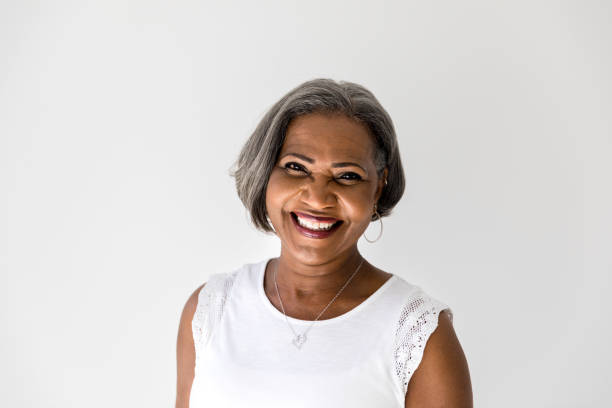 A happy African American senior woman smiles confidently at the camera.